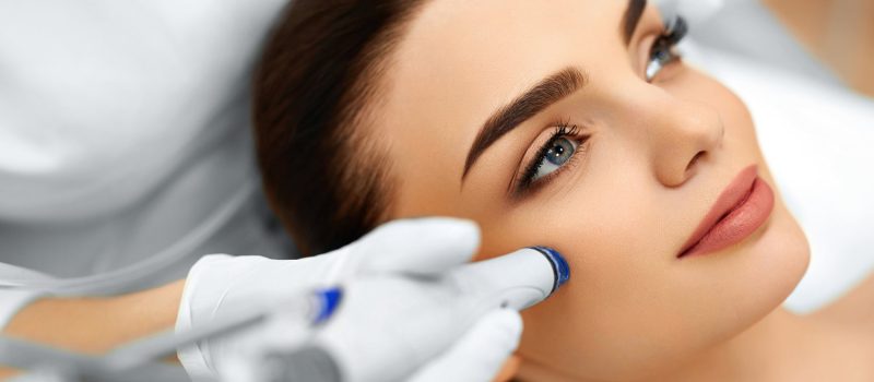 Face Skin Care. Close-up Of Woman Getting Facial Hydro Microdermabrasion Peeling Treatment At Cosmetic Beauty Spa Clinic. Hydra Vacuum Cleaner. Exfoliation, Rejuvenation And Hydratation. Cosmetology.